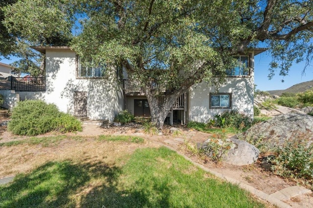 1480 Round Potrero Rd, Potrero, CA 91963 - view of property hidden behind natural elements with stucco siding and a front yard