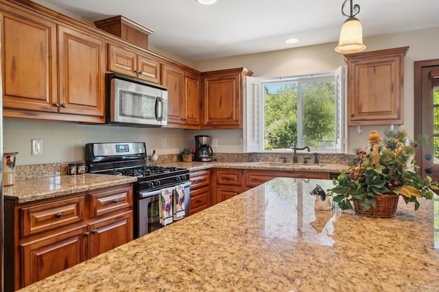 1480 Round Potrero Rd, Potrero, CA 91963 - kitchen featuring stainless steel appliances, light stone counters, brown cabinets, recessed lighting, and hanging light fixtures