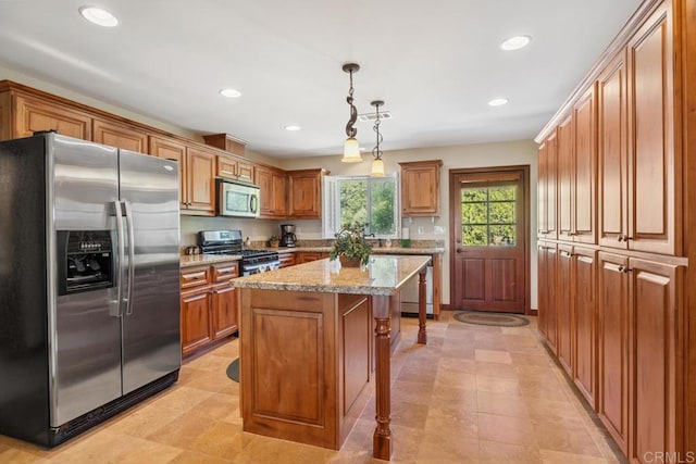 1480 Round Potrero Rd, Potrero, CA 91963 - kitchen featuring appliances with stainless steel finishes, recessed lighting, a center island, brown cabinetry, and decorative light fixtures