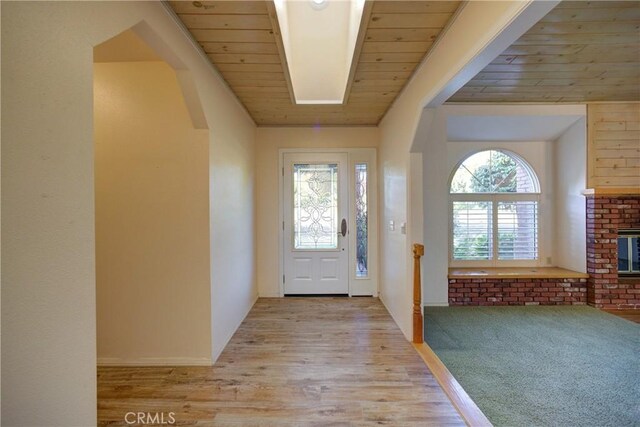 355 Via Vicente, Nipomo, CA 93444 - foyer with light wood-type flooring, wooden ceiling, arched walkways, and a brick fireplace