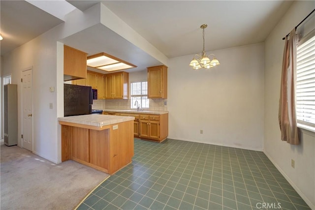 355 Via Vicente, Nipomo, CA 93444 - kitchen featuring freestanding refrigerator, a peninsula, a chandelier, carpet, and tile countertops