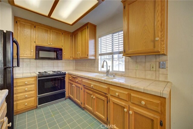 355 Via Vicente, Nipomo, CA 93444 - kitchen featuring black appliances, light tile patterned floors, tasteful backsplash, and tile countertops