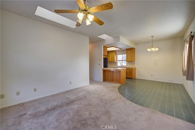 355 Via Vicente, Nipomo, CA 93444 - unfurnished living room with light carpet, a chandelier, a ceiling fan, and a skylight