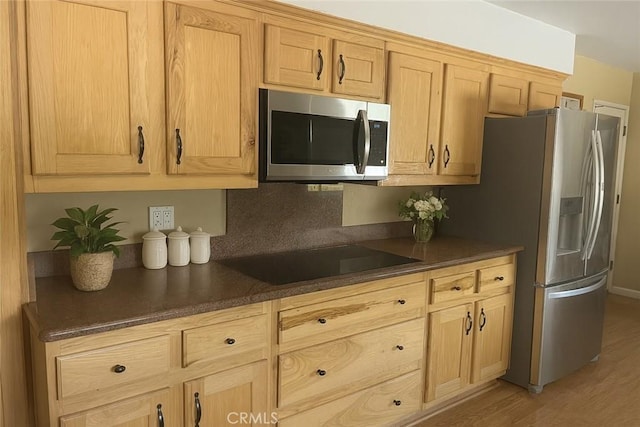 41150 Nona Ct, Hemet, CA 92544 - kitchen featuring appliances with stainless steel finishes, dark countertops, light wood finished floors, and light brown cabinetry
