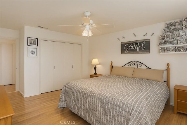 41150 Nona Ct, Hemet, CA 92544 - bedroom with light wood-style floors, a closet, and a ceiling fan