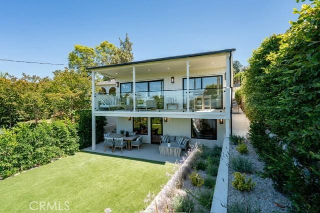 13817 Valley Vista Blvd, Sherman Oaks, CA 91423 - rear view of house featuring a balcony, an outdoor living space, a lawn, and a patio