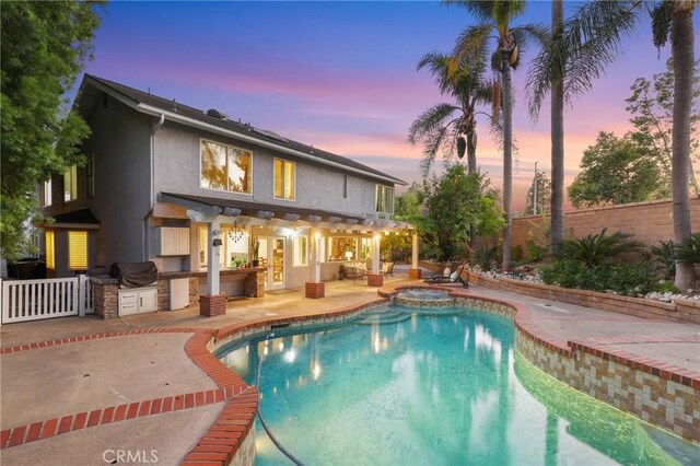24622 Cresta Ct, Laguna Hills, CA 92653 - view of pool with an outdoor kitchen, a fenced backyard, a patio area, and a pool with connected hot tub