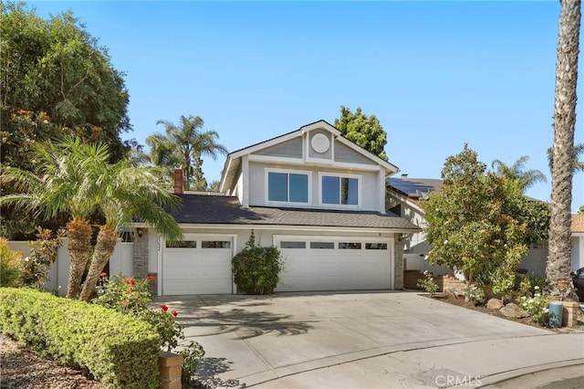 24622 Cresta Ct, Laguna Hills, CA 92653 - traditional-style house with concrete driveway, an attached garage, roof with shingles, and stucco siding