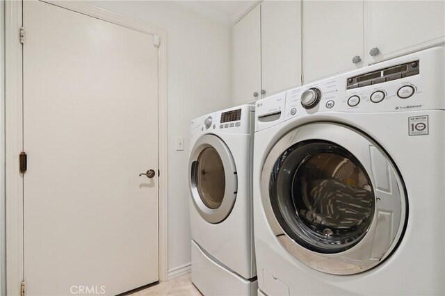 24622 Cresta Ct, Laguna Hills, CA 92653 - laundry area with independent washer and dryer, cabinet space, and light tile patterned flooring