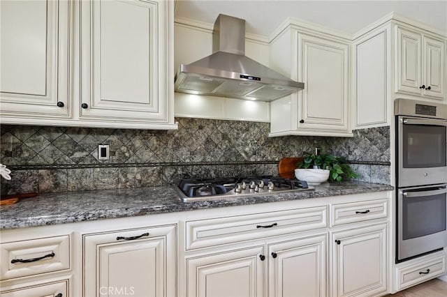 24622 Cresta Ct, Laguna Hills, CA 92653 - kitchen featuring wall chimney range hood, stainless steel appliances, tasteful backsplash, and dark stone countertops