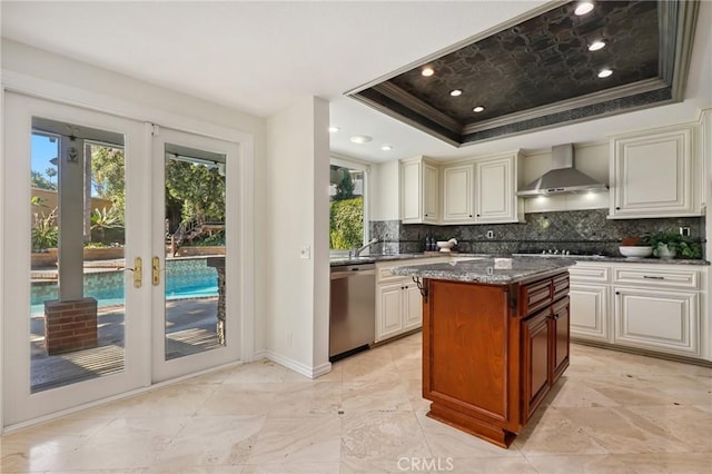 24622 Cresta Ct, Laguna Hills, CA 92653 - kitchen with dishwasher, wall chimney range hood, a tray ceiling, crown molding, and tasteful backsplash