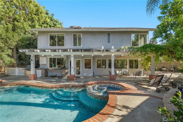 24622 Cresta Ct, Laguna Hills, CA 92653 - rear view of house with a pergola, stucco siding, a patio, and a pool with connected hot tub