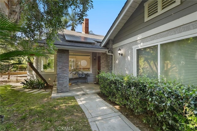 24622 Cresta Ct, Laguna Hills, CA 92653 - property entrance with solar panels and a chimney