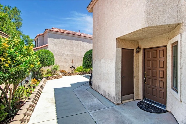 10254 Catalina Pl, Rancho Cucamonga, CA 91730 - doorway to property featuring stucco siding and a patio area