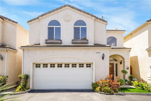 17787 Merridy St, Northridge, CA 91325 - mediterranean / spanish home featuring an attached garage, concrete driveway, and stucco siding