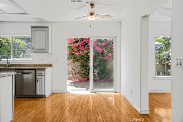 17787 Merridy St, Northridge, CA 91325 - kitchen with stainless steel dishwasher, a ceiling fan, light wood-style floors, and plenty of natural light