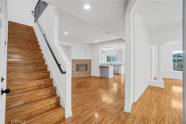17787 Merridy St, Northridge, CA 91325 - staircase featuring a tile fireplace, plenty of natural light, wood finished floors, and recessed lighting
