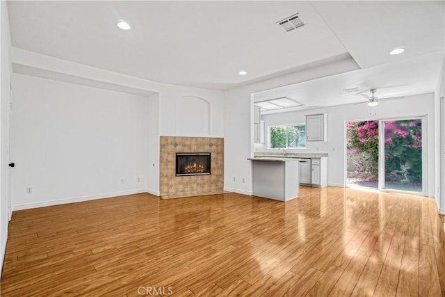 17787 Merridy St, Northridge, CA 91325 - unfurnished living room featuring light wood-type flooring, a tile fireplace, a ceiling fan, and recessed lighting
