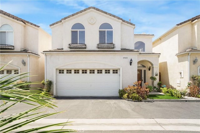 17787 Merridy St, Northridge, CA 91325 - mediterranean / spanish-style home with an attached garage, asphalt driveway, and stucco siding