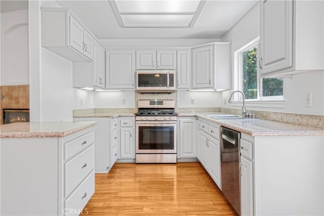 17787 Merridy St, Northridge, CA 91325 - kitchen with appliances with stainless steel finishes, light wood-style floors, white cabinets, and light stone counters