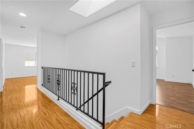 17787 Merridy St, Northridge, CA 91325 - corridor with an upstairs landing, wood finished floors, a skylight, and recessed lighting