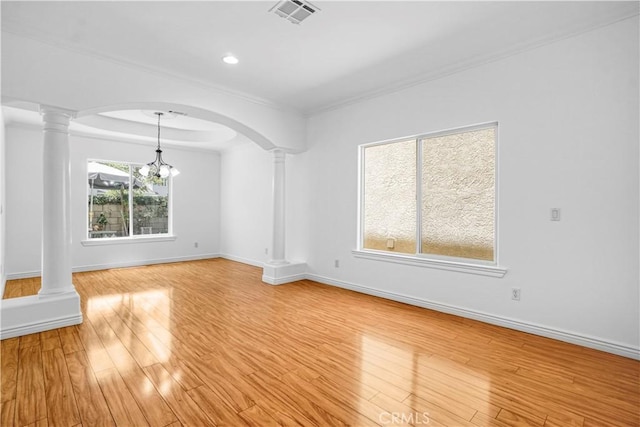 17787 Merridy St, Northridge, CA 91325 - spare room with ornate columns, arched walkways, light wood-style floors, ornamental molding, and a chandelier