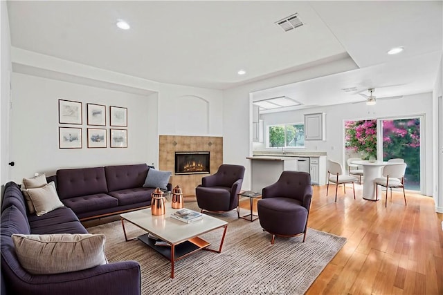 17787 Merridy St, Northridge, CA 91325 - living room with light wood-style flooring, a tiled fireplace, recessed lighting, and ceiling fan