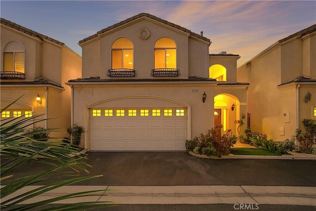 17787 Merridy St, Northridge, CA 91325 - mediterranean / spanish home featuring an attached garage, driveway, and stucco siding