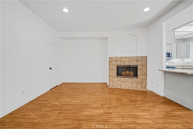 17787 Merridy St, Northridge, CA 91325 - unfurnished living room featuring light wood-style floors, a fireplace with flush hearth, and recessed lighting