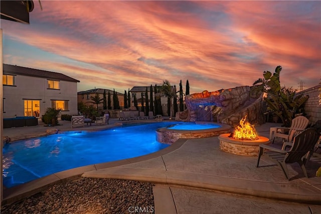 11715 Periwinkle Pl, Jurupa Valley, CA 91752 - pool at dusk featuring a fire pit and a patio