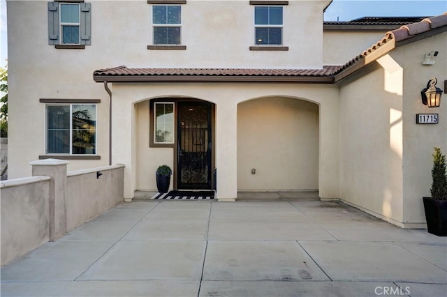 11715 Periwinkle Pl, Jurupa Valley, CA 91752 - property entrance with stucco siding and a tiled roof