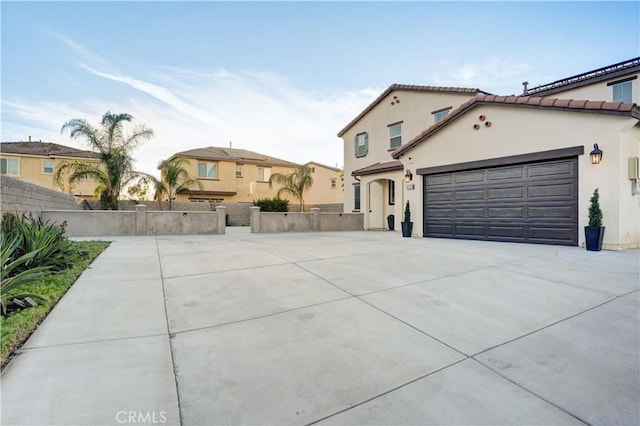 11715 Periwinkle Pl, Jurupa Valley, CA 91752 - mediterranean / spanish house with concrete driveway, a tile roof, an attached garage, and stucco siding