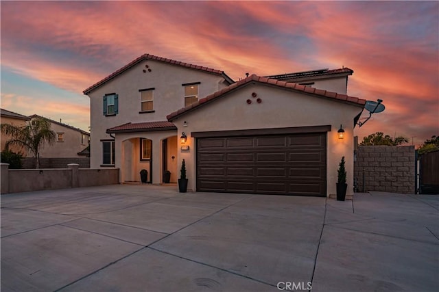 11715 Periwinkle Pl, Jurupa Valley, CA 91752 - mediterranean / spanish home with driveway, a garage, stucco siding, and a tile roof