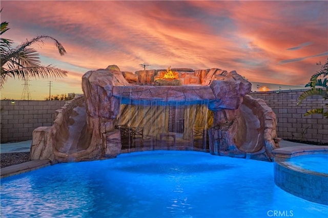 11715 Periwinkle Pl, Jurupa Valley, CA 91752 - pool at dusk with a pool with connected hot tub and a fire pit