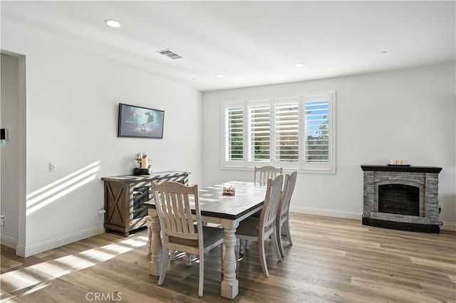 11715 Periwinkle Pl, Jurupa Valley, CA 91752 - dining space with light wood finished floors, recessed lighting, and a stone fireplace