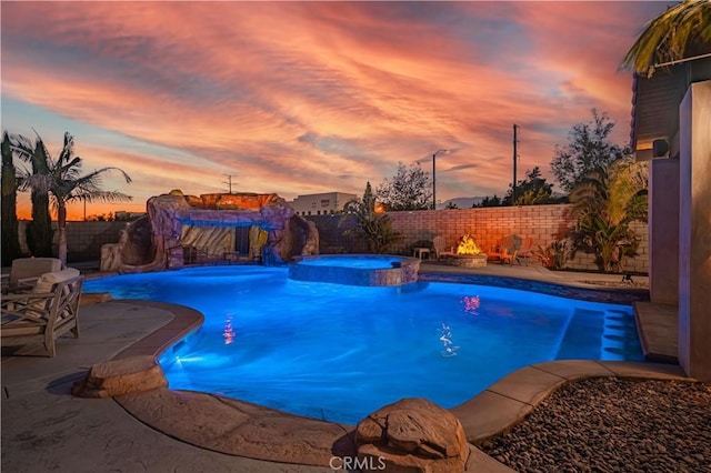 11715 Periwinkle Pl, Jurupa Valley, CA 91752 - view of swimming pool with a fenced backyard, a patio, a pool with connected hot tub, and a fire pit