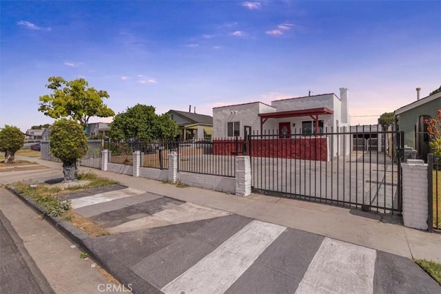 727 E 94th St, Los Angeles, CA 90002 - view of front of property with a fenced front yard, a gate, and stucco siding