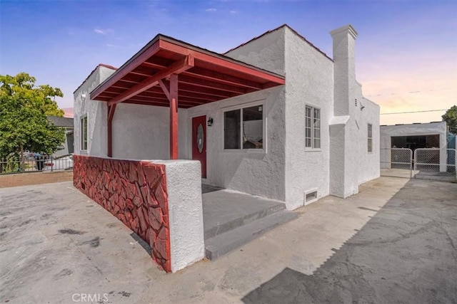 727 E 94th St, Los Angeles, CA 90002 - view of front of home featuring stucco siding and a chimney