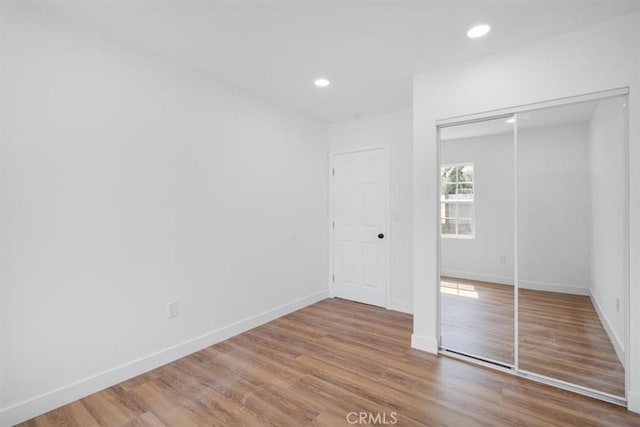 727 E 94th St, Los Angeles, CA 90002 - unfurnished bedroom with wood finished floors, a closet, and recessed lighting