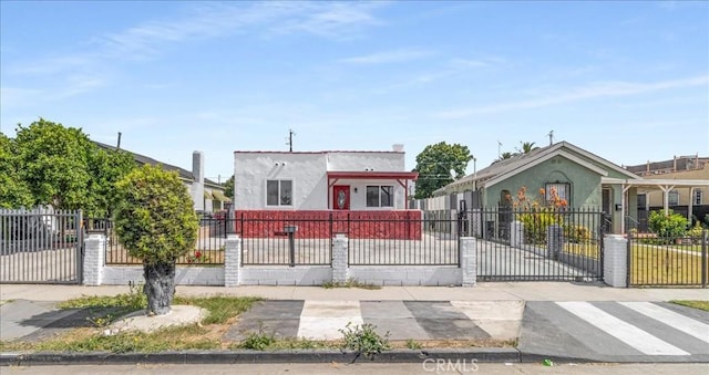 727 E 94th St, Los Angeles, CA 90002 - view of front of house featuring a fenced front yard and stucco siding