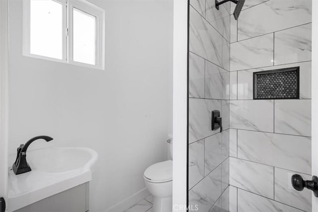 727 E 94th St, Los Angeles, CA 90002 - bathroom featuring marble finish floors, tiled shower, and vanity