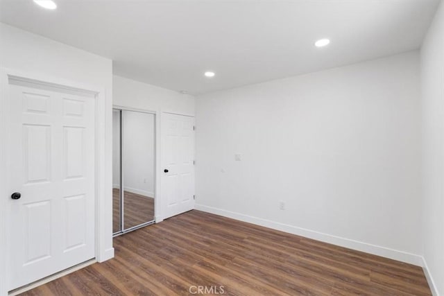 727 E 94th St, Los Angeles, CA 90002 - unfurnished bedroom with dark wood-style flooring, a closet, and recessed lighting