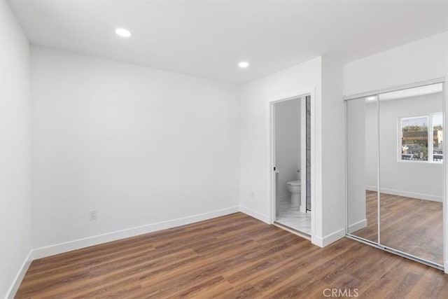 727 E 94th St, Los Angeles, CA 90002 - unfurnished bedroom featuring a closet, wood finished floors, recessed lighting, and ensuite bathroom