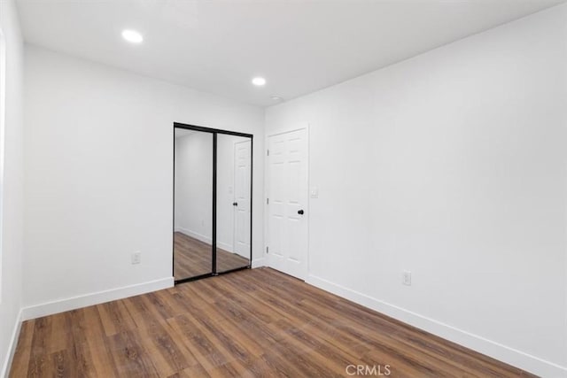727 E 94th St, Los Angeles, CA 90002 - unfurnished bedroom with wood finished floors, recessed lighting, and a closet