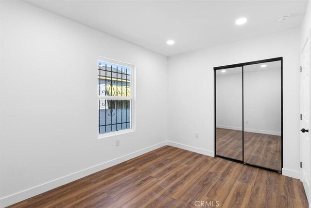 727 E 94th St, Los Angeles, CA 90002 - unfurnished bedroom with wood finished floors, recessed lighting, and a closet