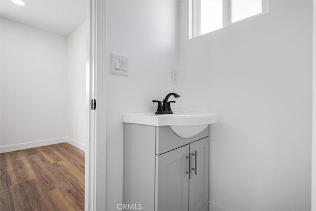 727 E 94th St, Los Angeles, CA 90002 - bathroom with wood finished floors, vanity, and recessed lighting