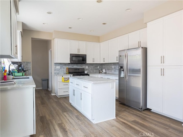 1870 Rosemont Cir, San Jacinto, CA 92583 - kitchen featuring appliances with stainless steel finishes, tasteful backsplash, wood finished floors, white cabinets, and recessed lighting