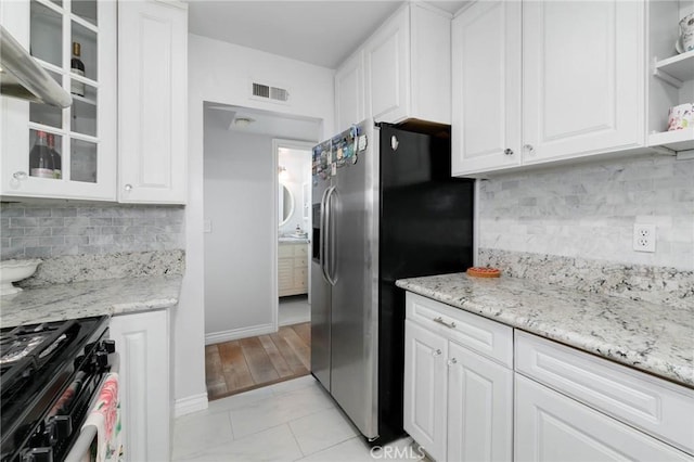 225 W Mission Rd Unit A, San Gabriel, CA 91776 - kitchen featuring gas range oven, stainless steel fridge, white cabinetry, open shelves, and tasteful backsplash