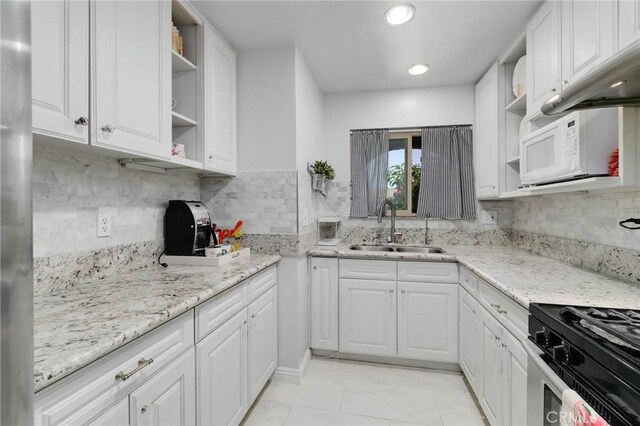 225 W Mission Rd Unit A, San Gabriel, CA 91776 - kitchen with open shelves, white microwave, white cabinetry, backsplash, and recessed lighting