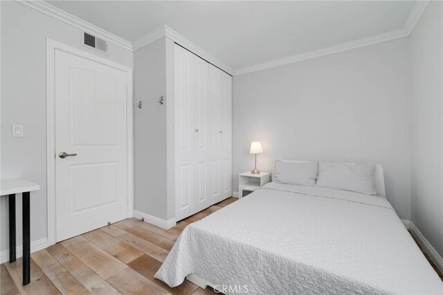 225 W Mission Rd Unit A, San Gabriel, CA 91776 - bedroom with wood finished floors, crown molding, and a closet